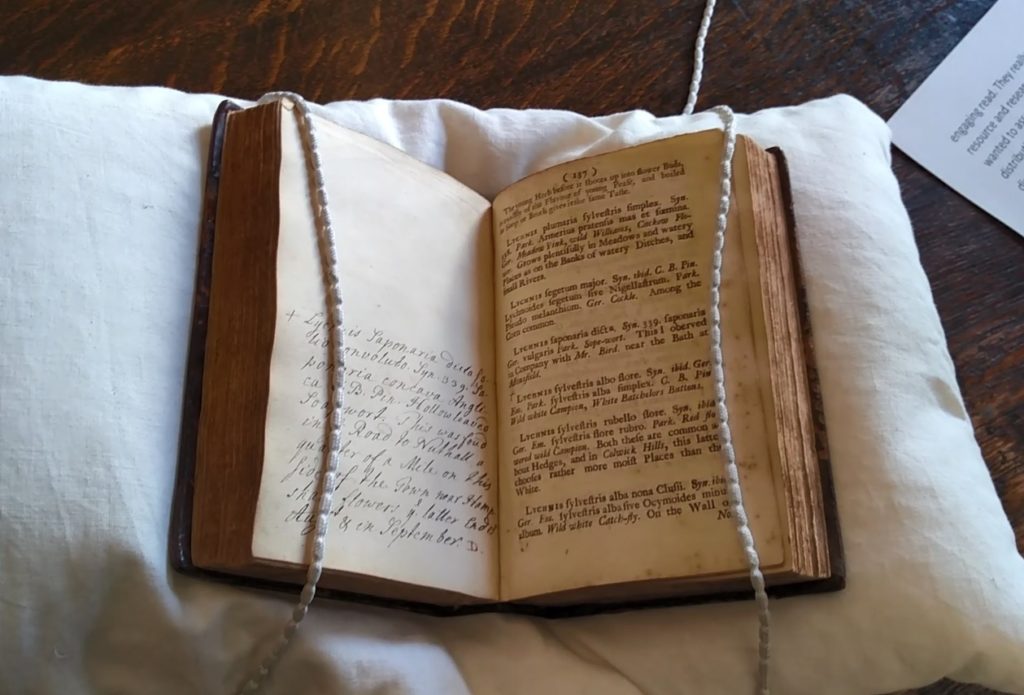Deering's Catalogue of Plants, open on a book cushion