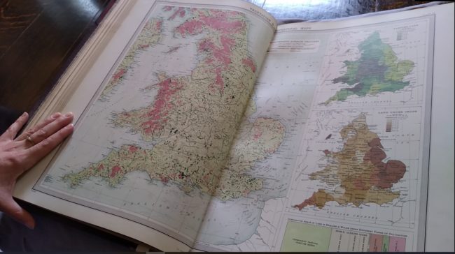 Open page of an atlas showing various colour maps of England and Wales